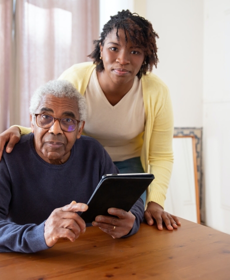Pensioner with Caretaker on Tablet