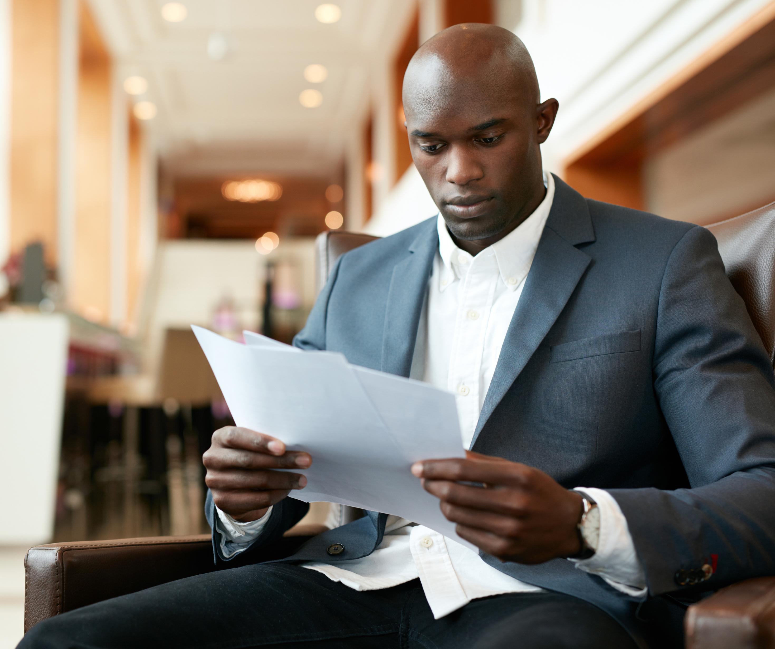 A Motswana businessman looking at documents.