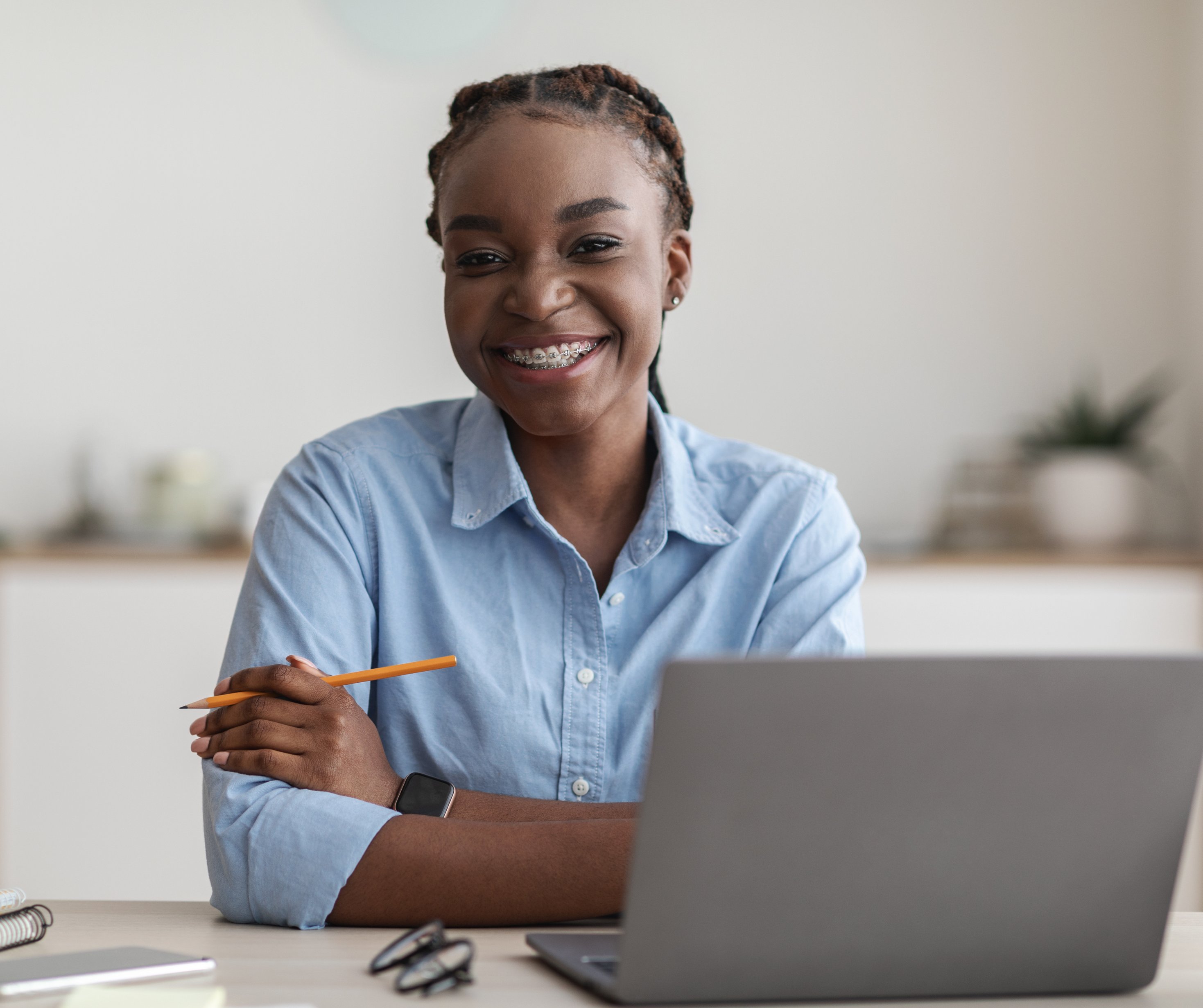 A 25-year-old Batswana woman at office desk.