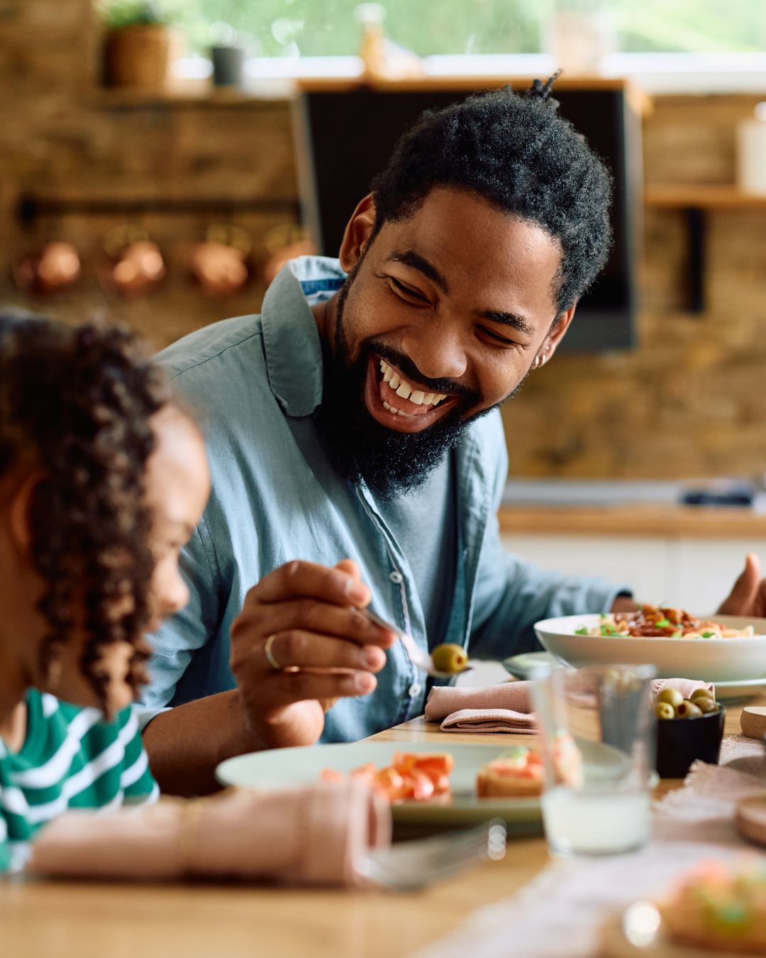 Father and daughter at breakfast table