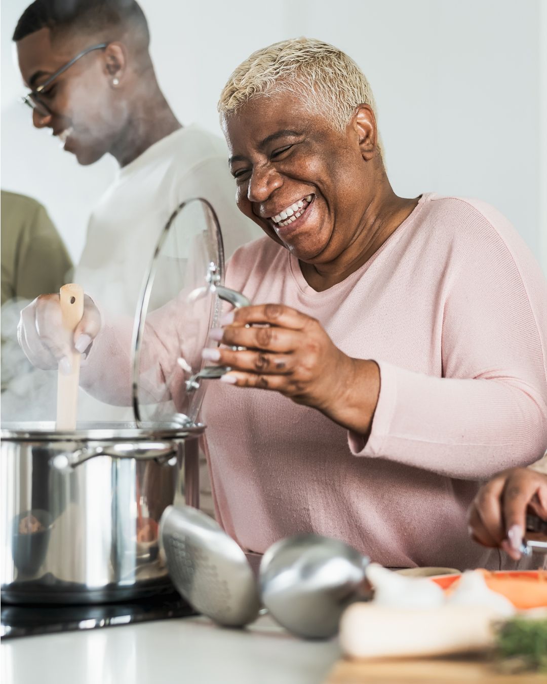 Grandmother cooking with grandson