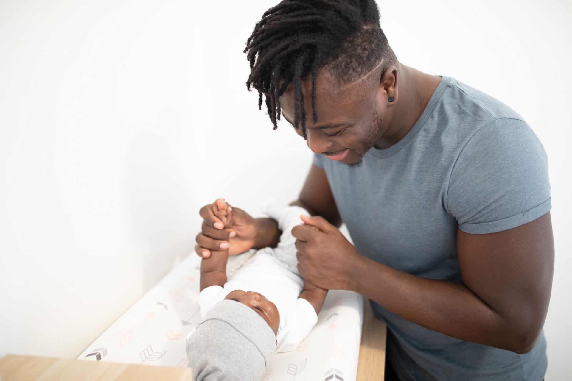 Father with baby child in cot