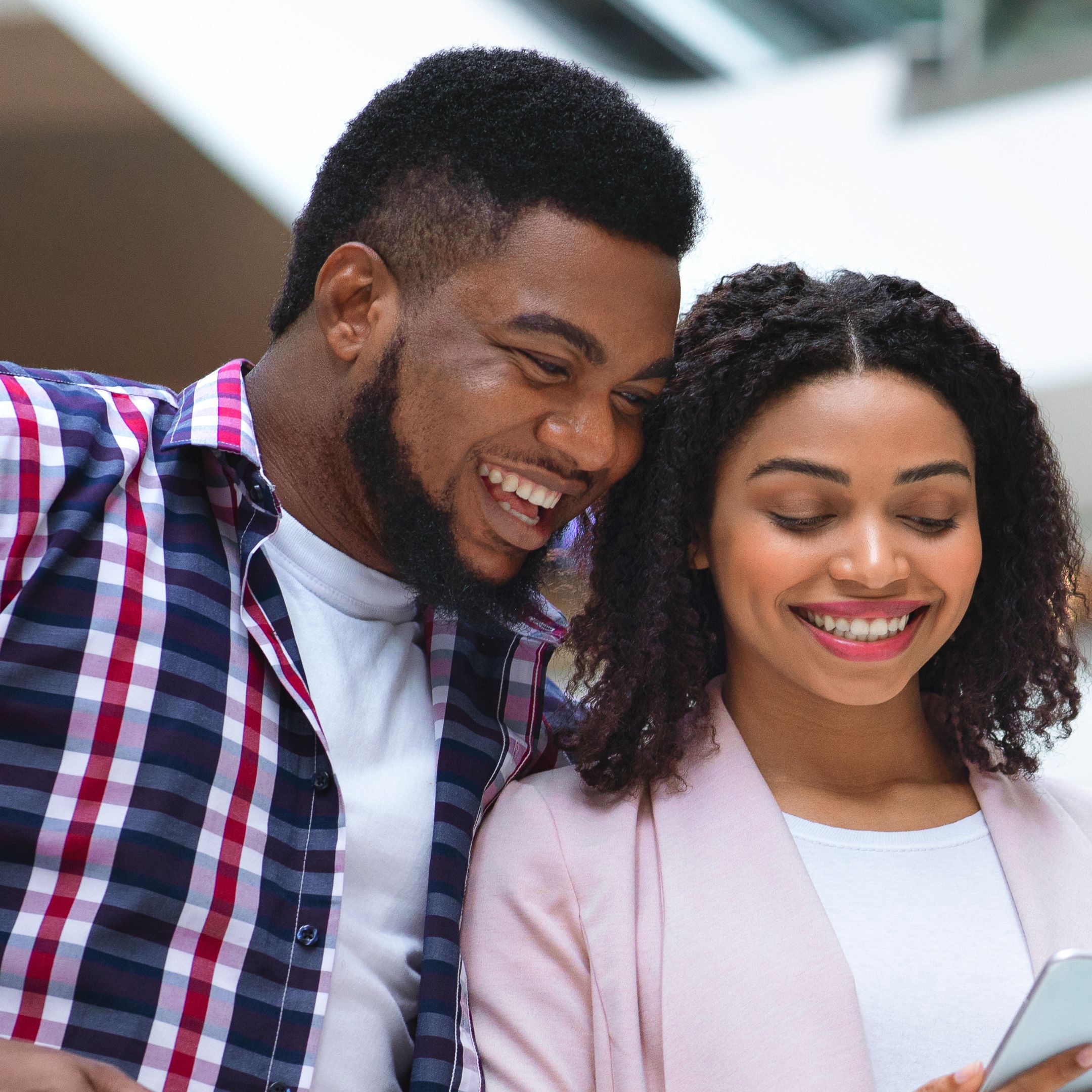 A young couple smiling in shopping mall