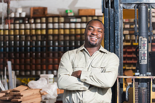 Business Man standing in front of his workshop