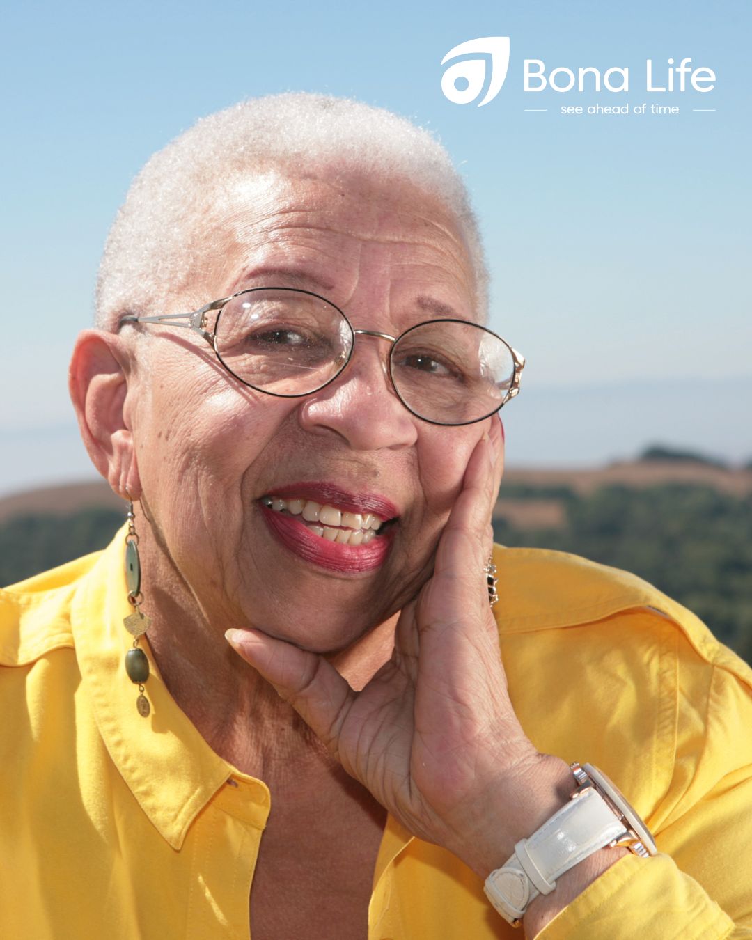 Elderly women in yellow dress smiling