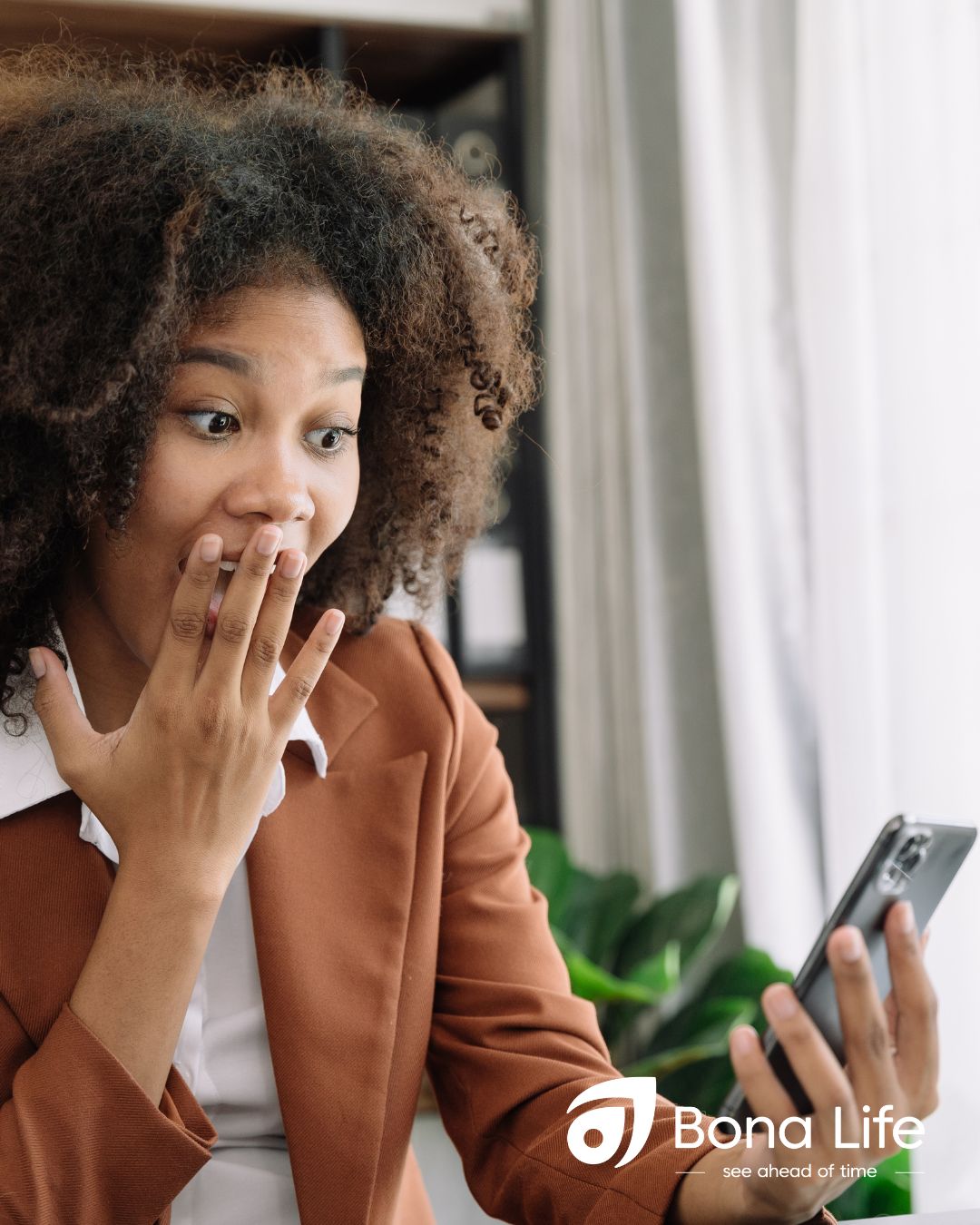 Professional women looking at phone with a astonished reaction